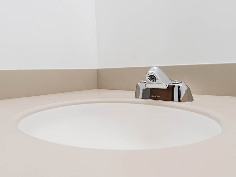 A “ligature-resistant” sink includes fixtures and plumbing designed to reduce self-harm in behavioral healthcare settings.