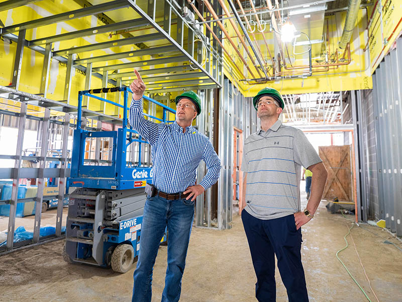 Wade Jueneman, McElroy's vice president, and Jimmy Thomas, McElroy's commercial project manager, review construction of the Washburn University School of Law building.