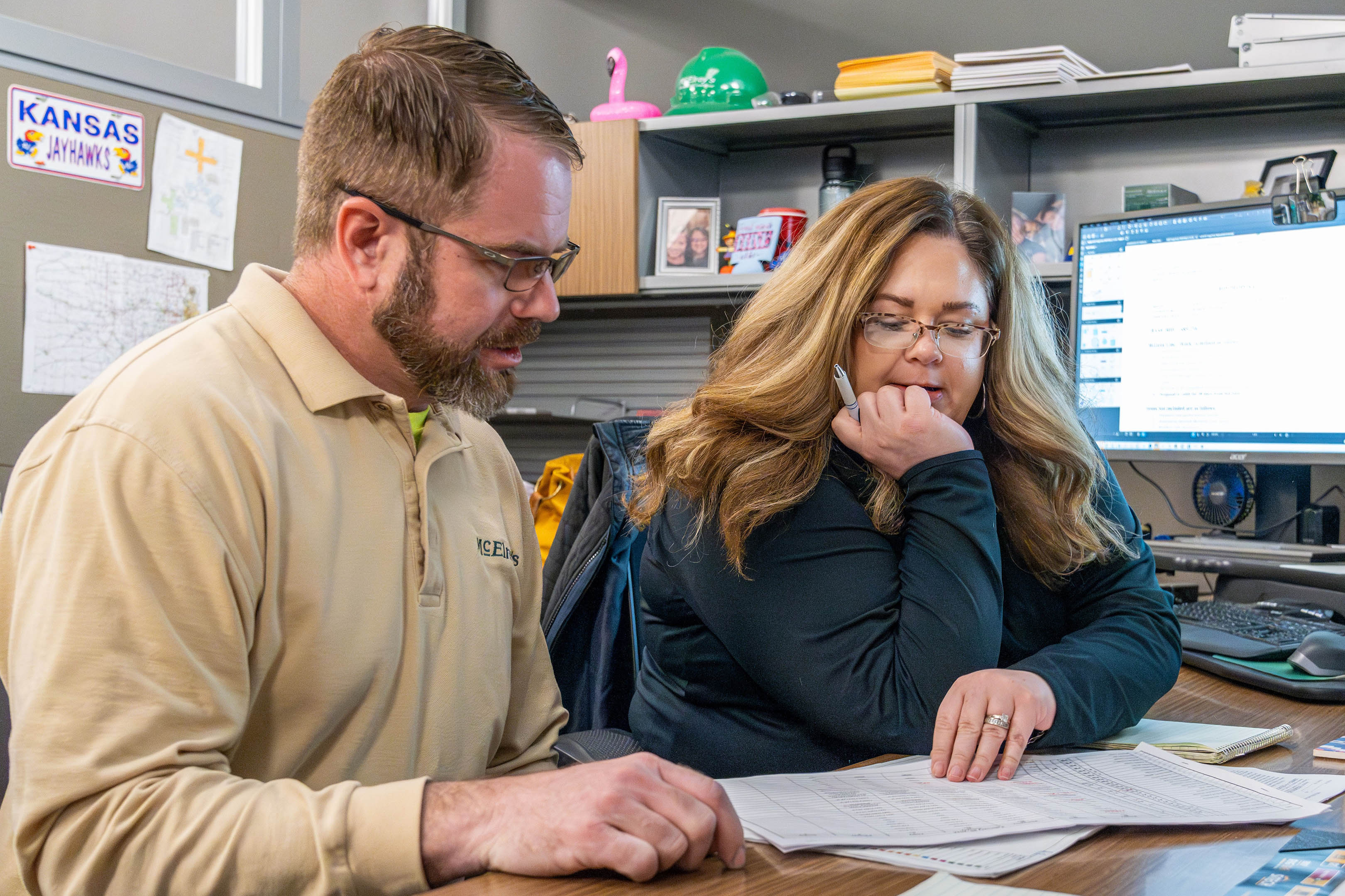 McElroy’s commercial-construction assistant project manager Kristen Colvin reviews workforce schedules with Scott Schneider.