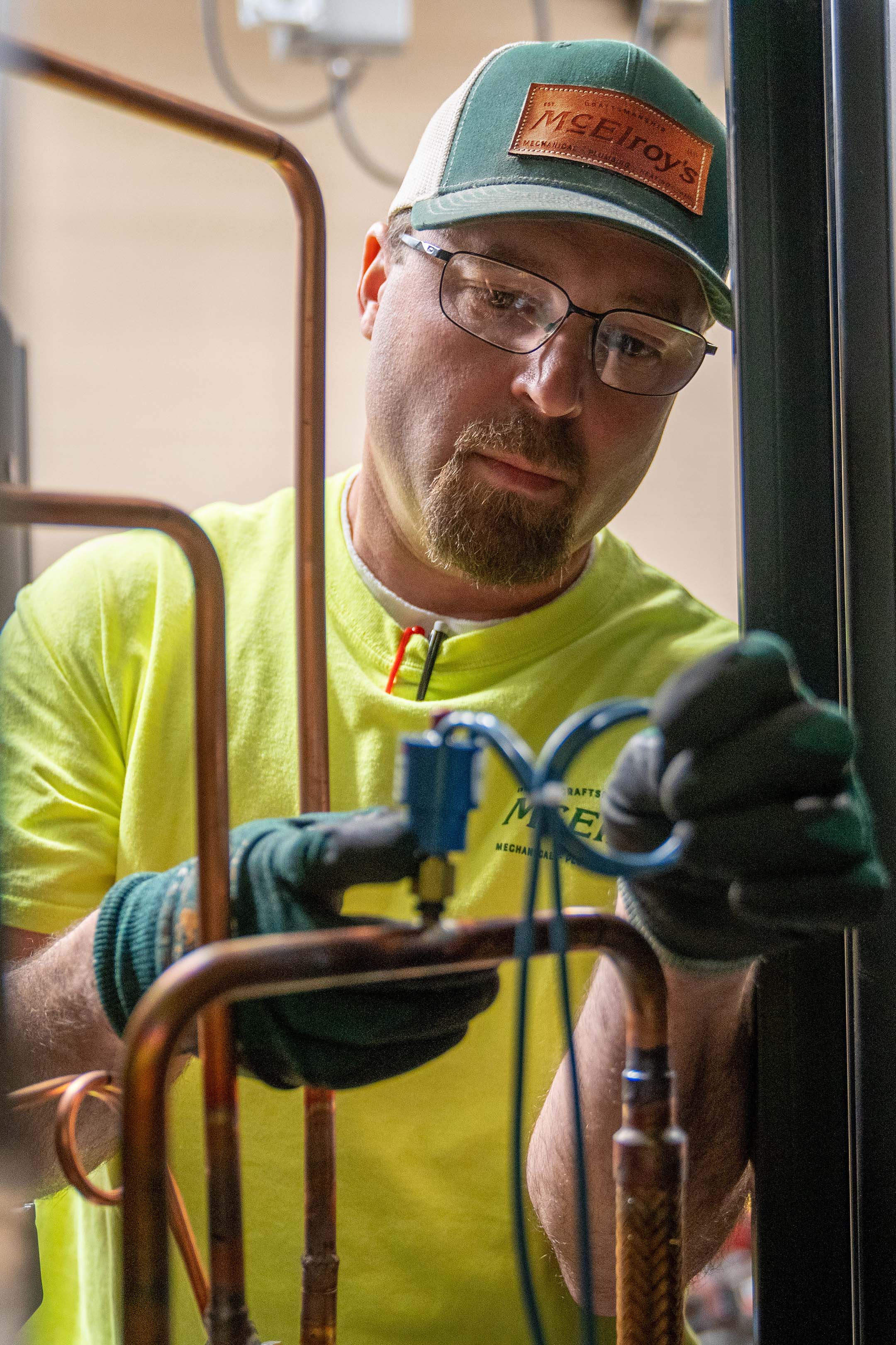 Kirk York, McElroy’s commercial-construction plumber/pipefitter, makes adjustments to a commercial HVAC system.