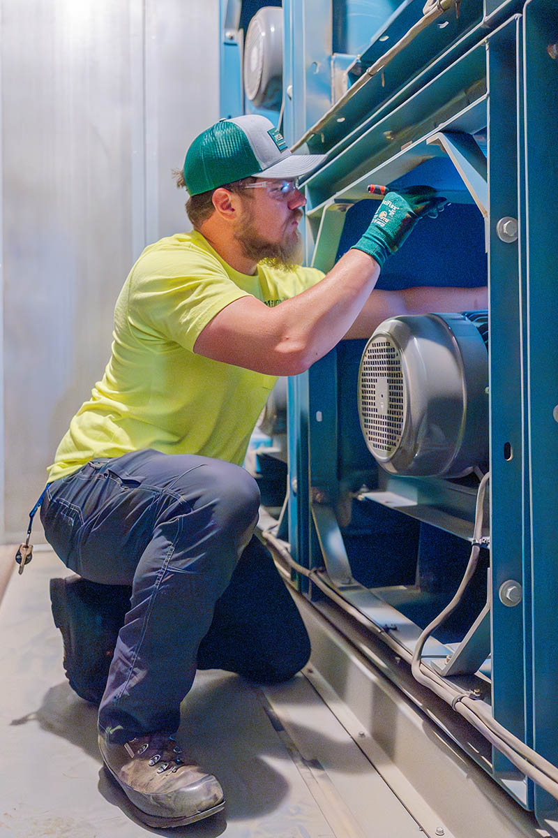 Bobby Millard, McElroy’s commercial HVAC service technician, conducts an inspection of HVAC equipment for a school district.