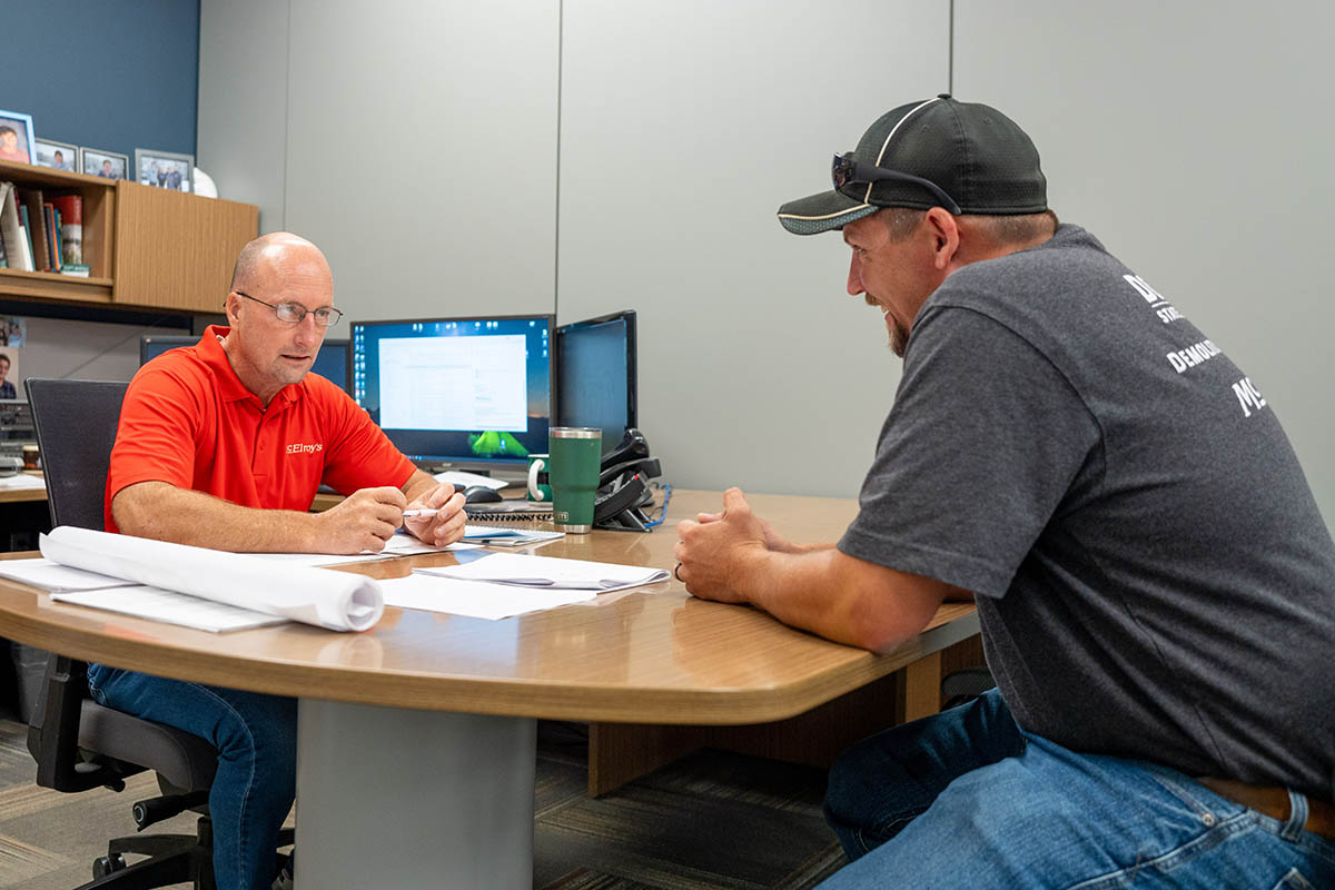 Preston Bond, McElroy’s commercial construction project supervisor, discuss a job with McElroy’s President Wade Jueneman.