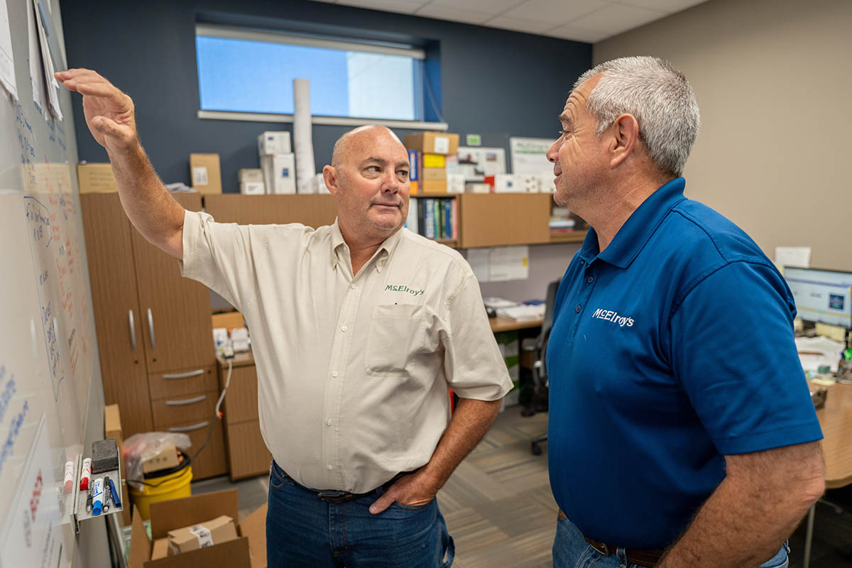 Haig Sarkesian and Greg Hunsicker, leader of the McElroy’s residential HVAC team, discuss system installation projects.