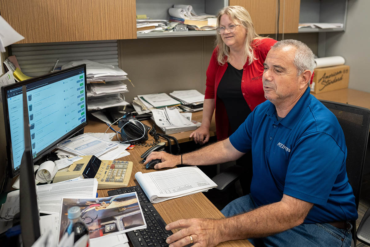 Haig Sarkesian and Julie Schirmer, McElroy’s customer service rep, consider a variety of HVAC equipment options for proposal.