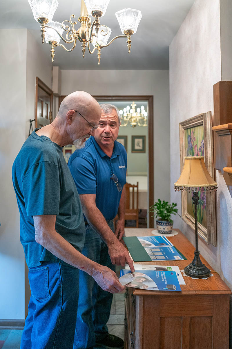 Haig Sarkesian, McElroy’s residential HVAC sales, confers with a homeowner about new HVAC system options.