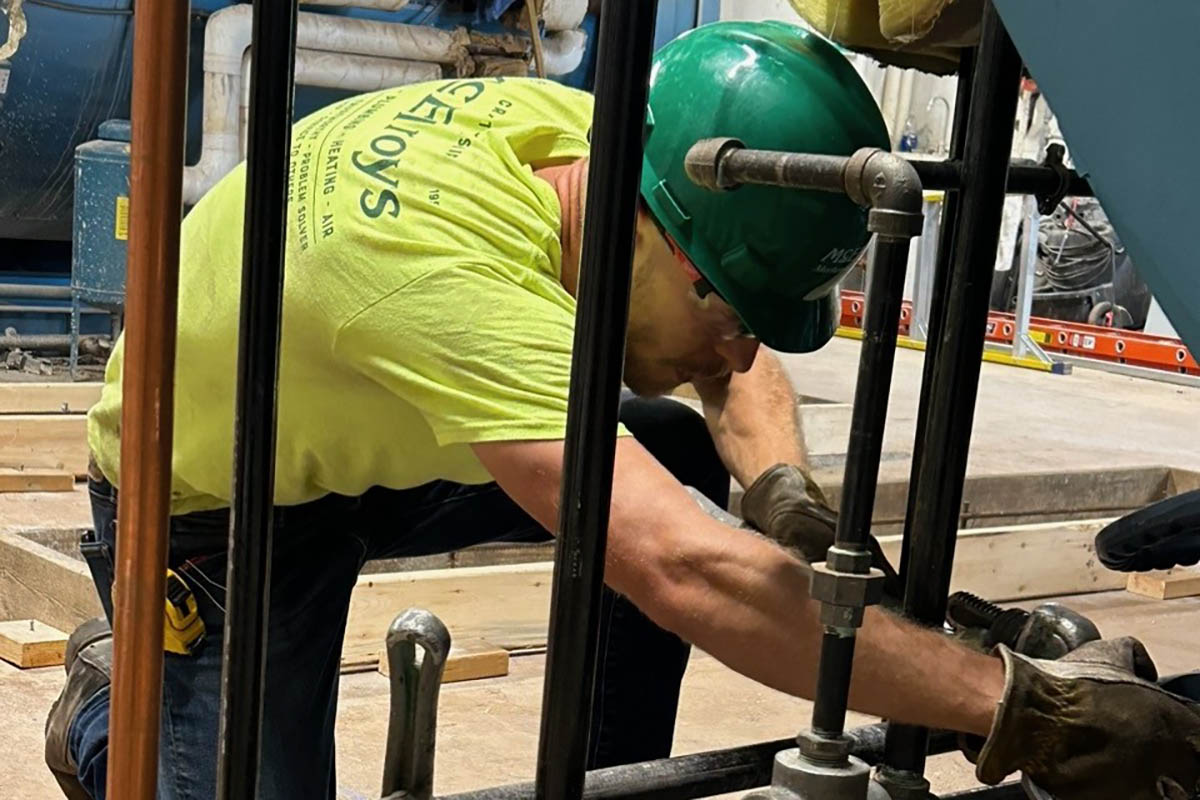 Max Lowe, KSU architectural engineering student, assists with a commercial construction piping project during his McElroy’s summer internship.