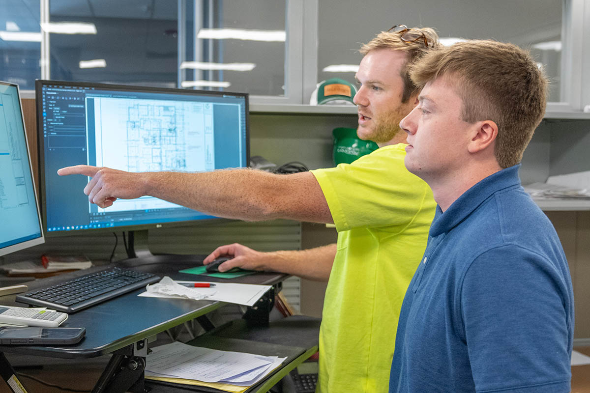 Luke Webber, KSU mechanical engineering student and McElroy’s summer intern, discusses project estimating with Adam Outlaw of McElroy’s.