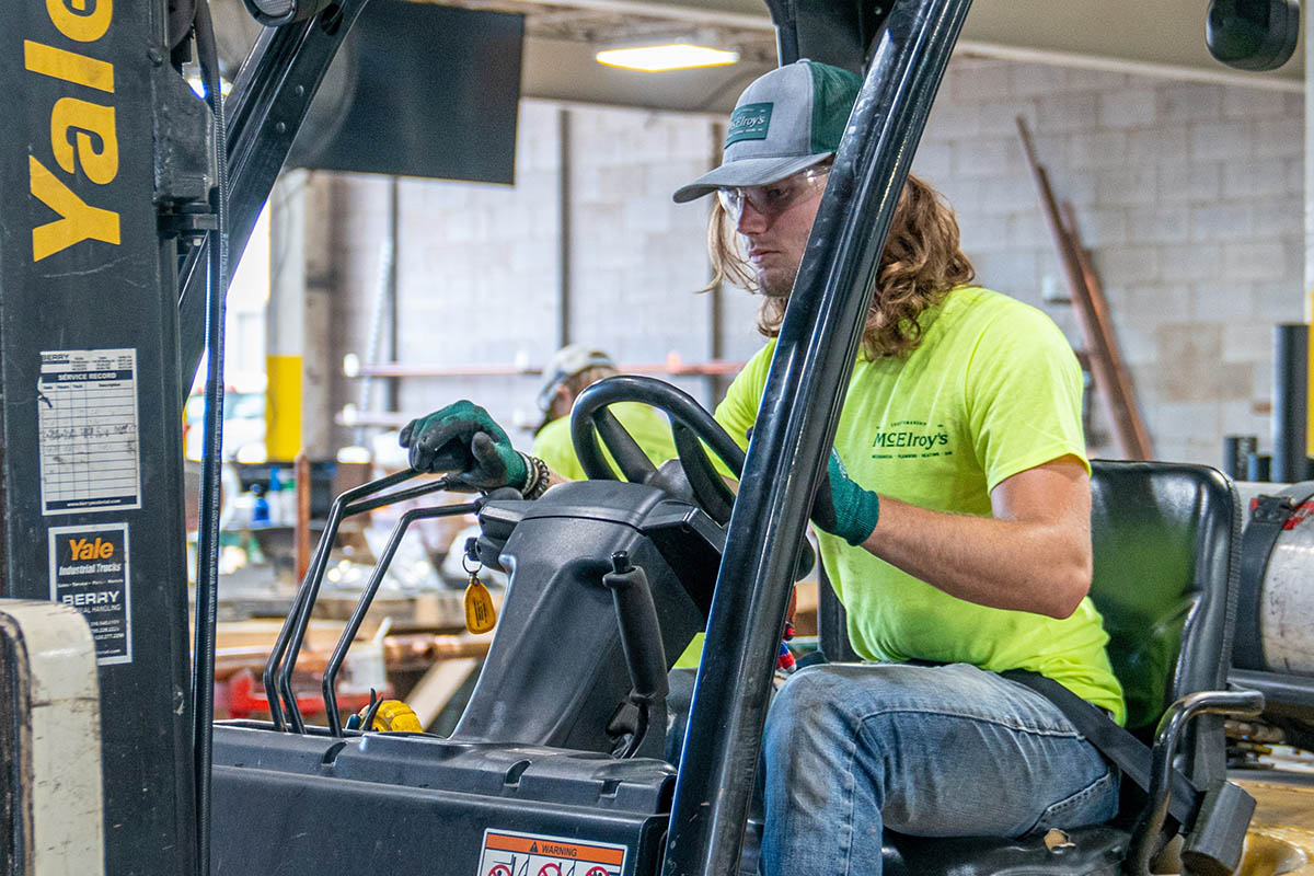 Garrett Hammer helps with materials handling while working as  a summer intern in the McElroy’s plumbing/pipefitting fabrication shop.