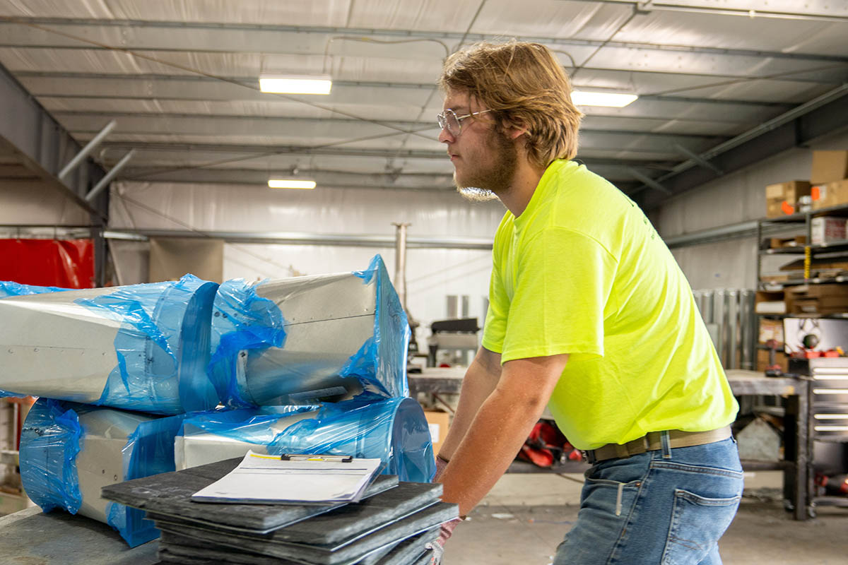 Ty Beam, summer intern in the McElroy’s sheet-metal fabrication shop, prepares to load duct materials for delivery to technicians in the field.