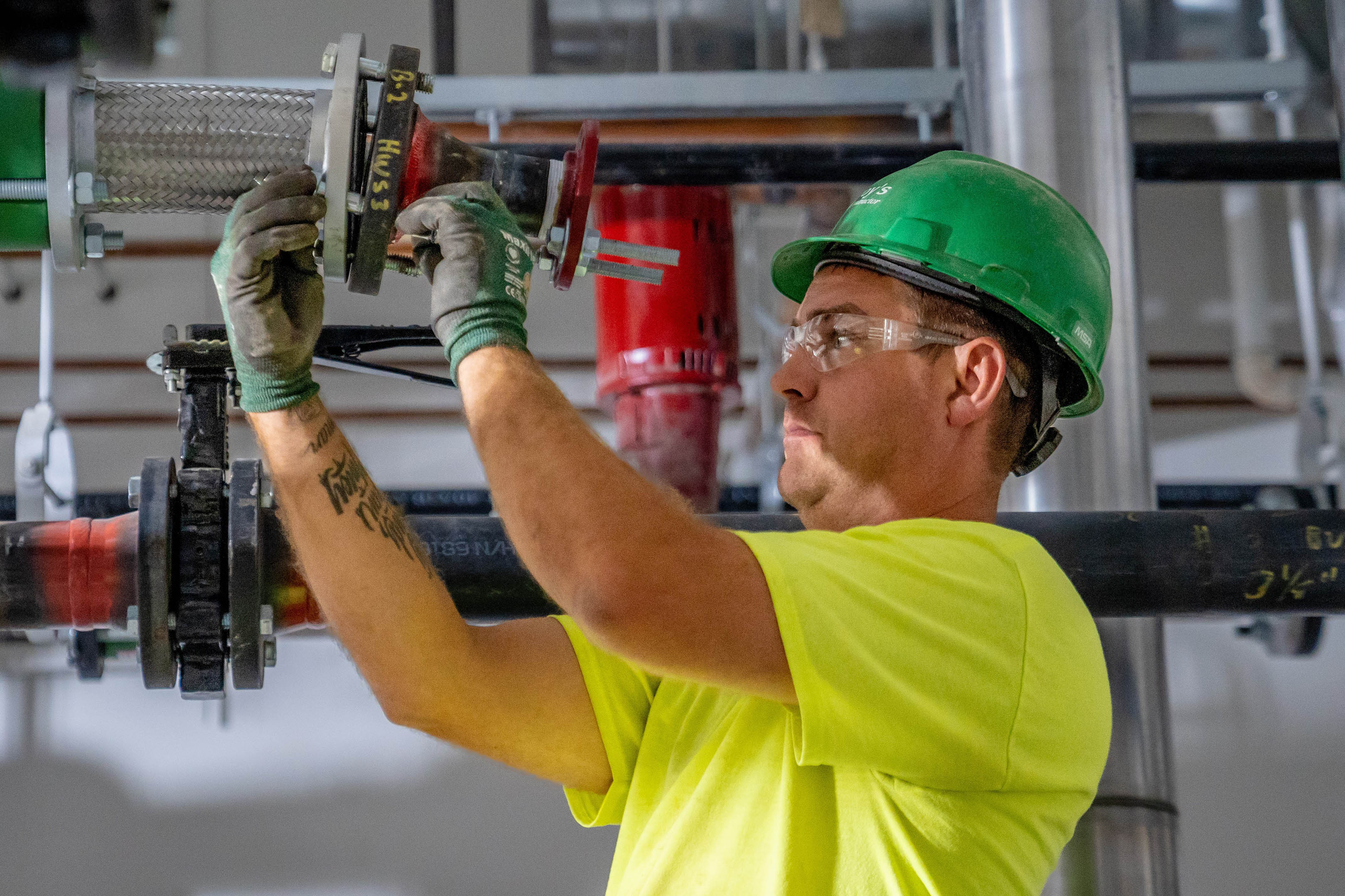 Dusty Bergquist, McElroy’s commercial construction pipefitting foreman, works on piping at the Washburn University Law School.