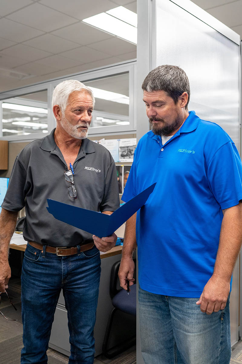 Luke Dumler, McElroy’s plumbing service manager, meets with Rendy Habiger, McElroy’s plumbing service sales.