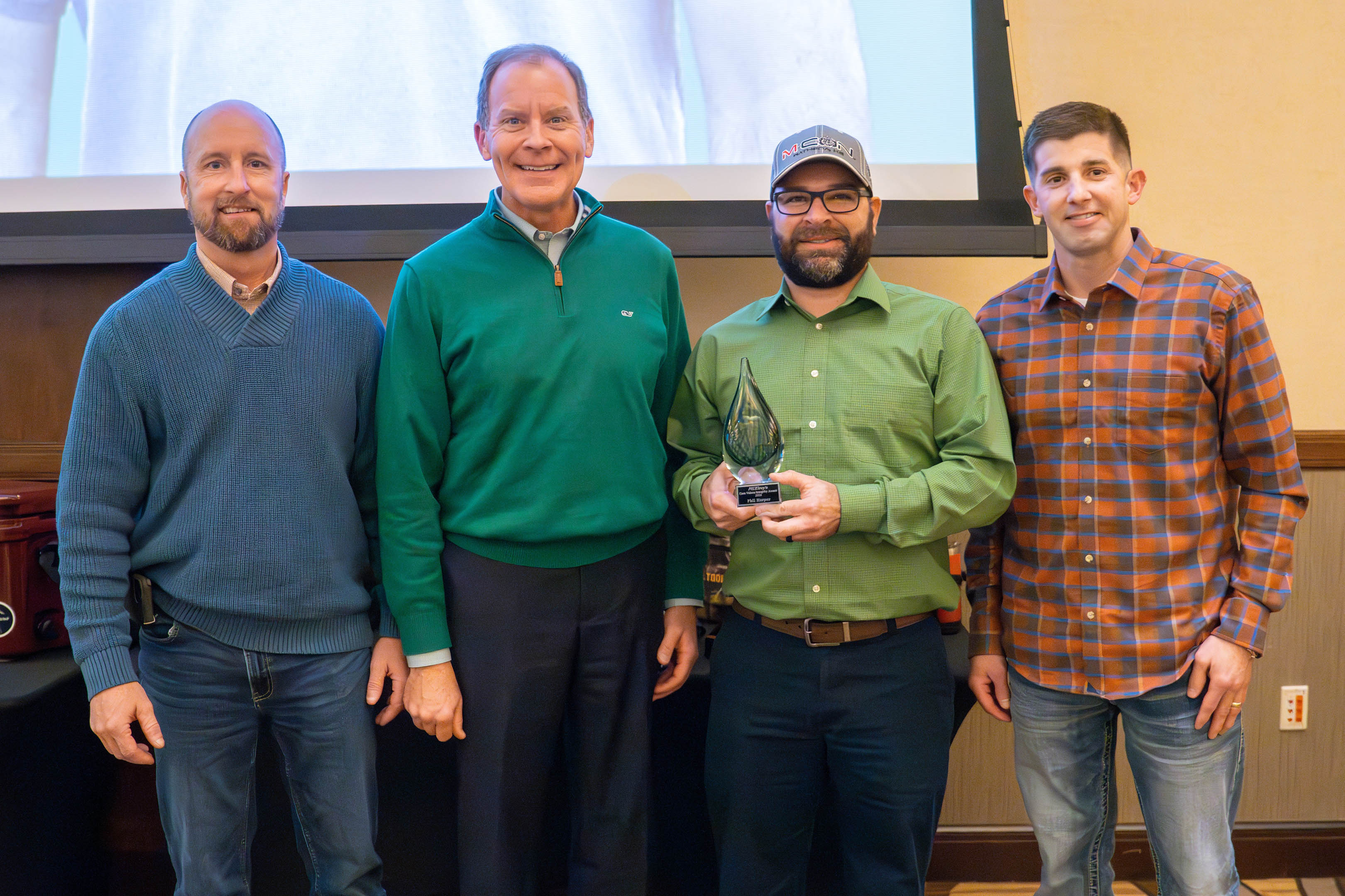 Wade Jueneman, Dan Beal and Jimmy Thomas present the 2024 McElroy's Core Values Integrity Award to Phil Harper.