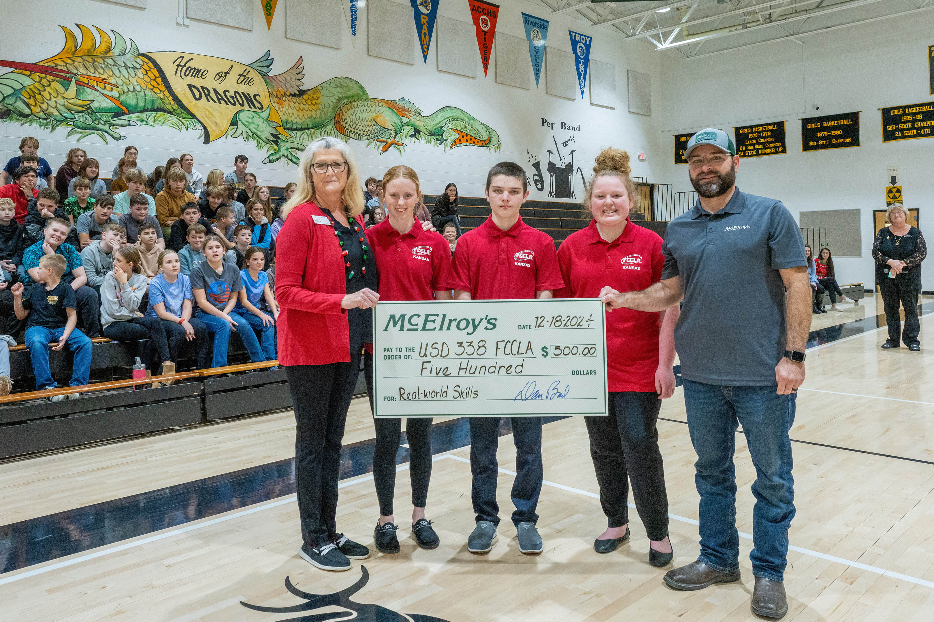 Phil Harper presents his $500 honorary donation to the Valley Falls USD 338 Family, Career and Community Leaders of America program.